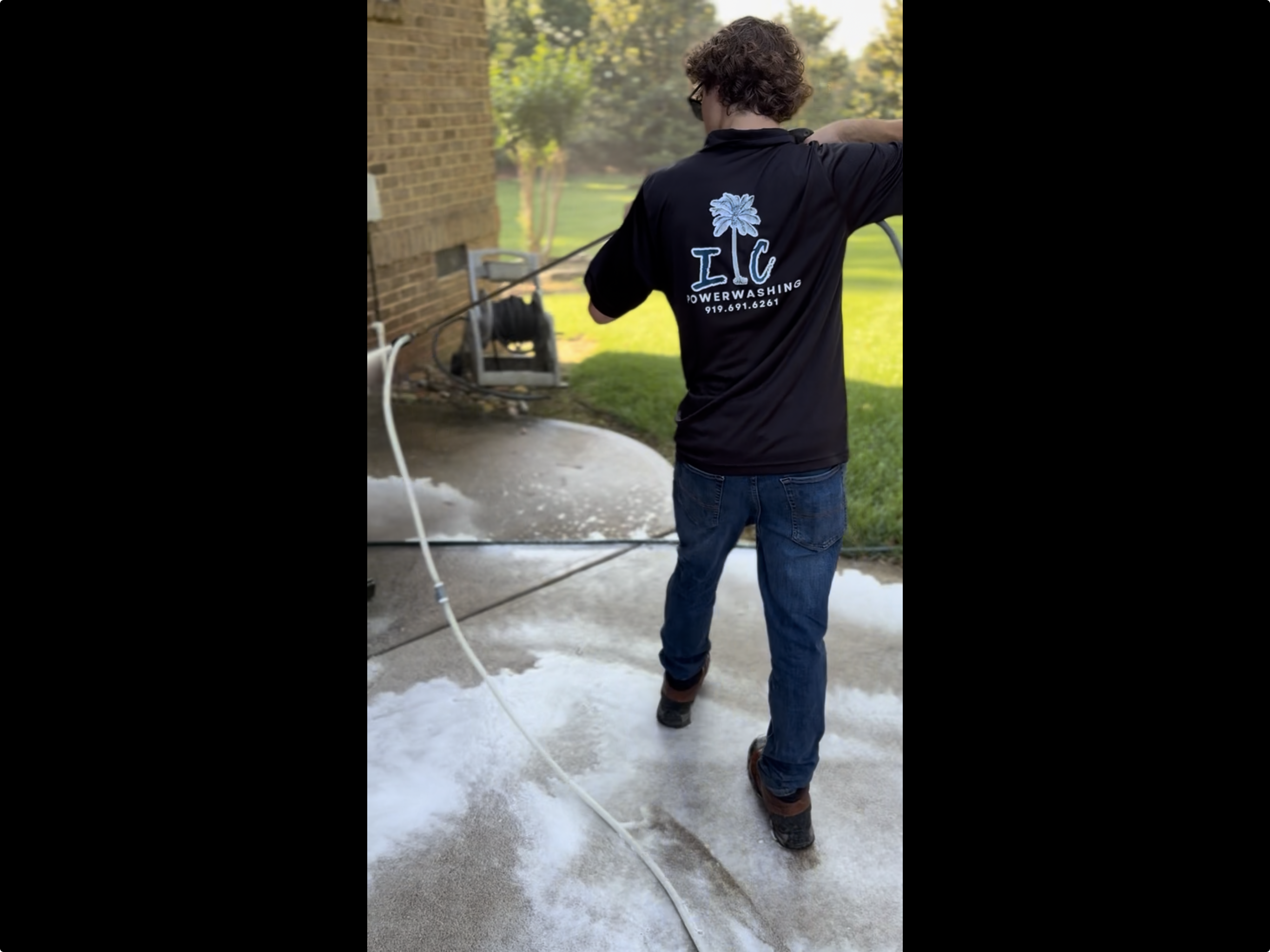 IC Power Washing team member in company shirt on a job in Wake Forest, NC